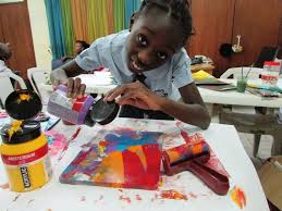 A young girl supported by Sickle Cell Foundation Nigeria takes part in an arts and wellbeing session